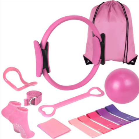 Pink pilates kit with exercise ring, resistance bands, socks, yoga ball, and storage bag